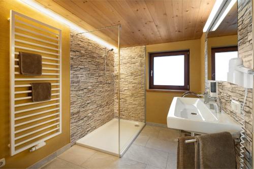 a bathroom with a glass shower and a sink at Haus Gafrina in Schruns