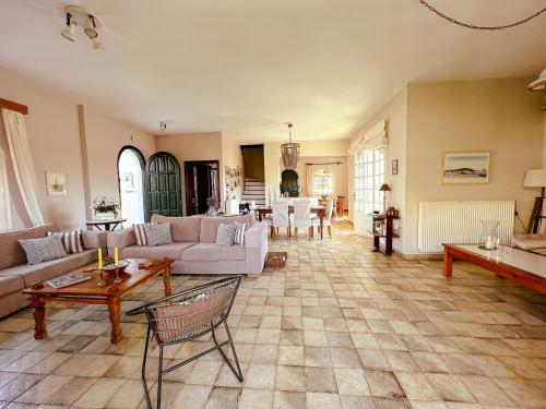a living room with a couch and a table at Villa Avly in Maleme
