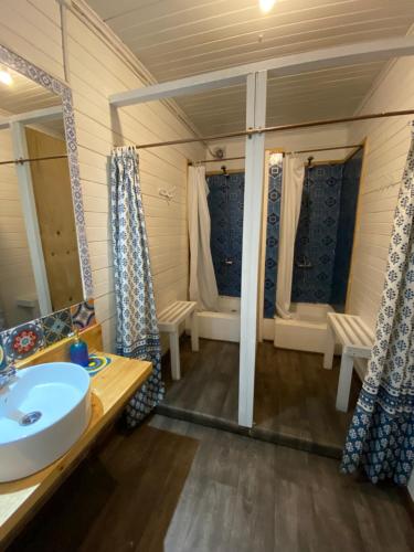 a bathroom with a sink and a mirror at La Guapa Hostel in Puerto Varas