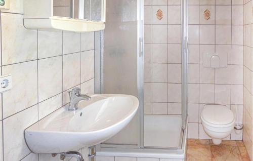 a bathroom with a sink and a toilet at Amazing Home In Eichigt-ot Sssebach With 2 Bedrooms And Internet in Eichigt
