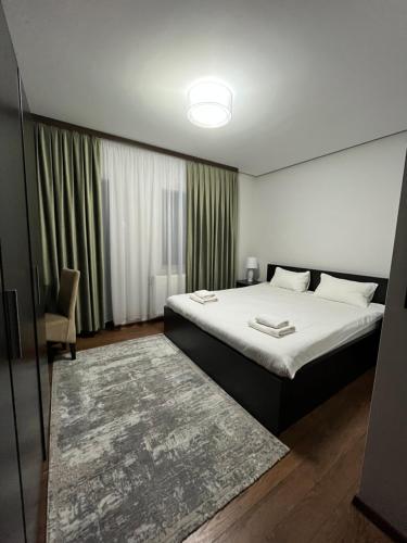 um quarto com uma cama e uma janela com um tapete em Pensiunea Miorița Putna em Putna