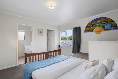 1 dormitorio con 1 cama y una pintura en la pared en Comfy One Bed Delight - Parking - WIFI - Netflix, en Auckland