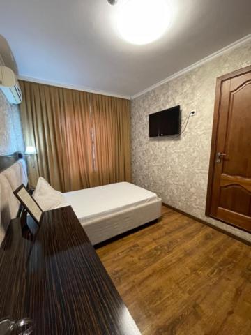 a small room with a bed and a table in it at Diar in Atyrau