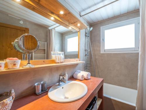 a bathroom with a sink and a mirror at Charmant appart central avec parking à l'Alpe d'Huez - FR-1-645-18 in LʼHuez