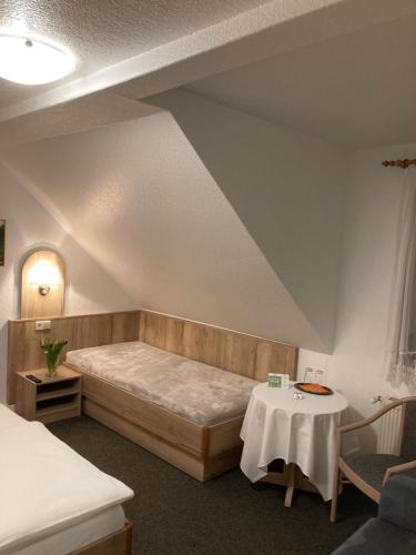 a room with a bed and a table in it at Pension Haufe in Ohorn