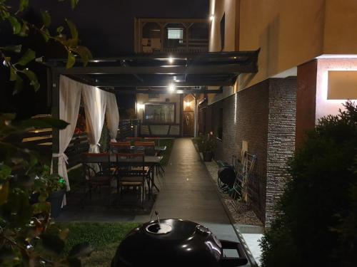 a patio with tables and chairs in a building at Pokoje Sandra I in Łeba