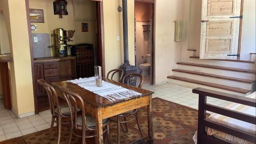 a dining room with a wooden table and chairs at Finca La Encantada in San Rafael