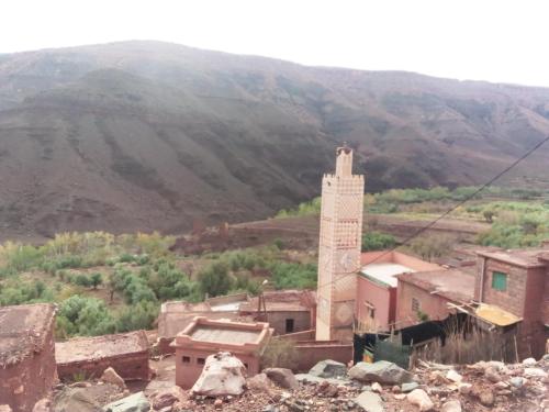 an old building with a mountain in the background at Dar Zara in Ouarzazate