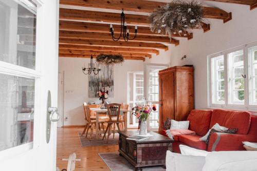 a living room with a red couch and a table at Willa Tyrolczyk in Karpacz