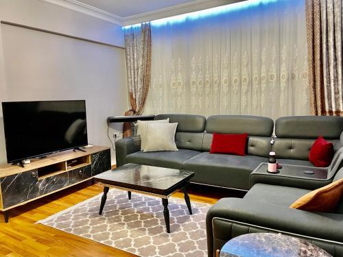 a living room with a couch and a flat screen tv at Bigger house in Beylikduzu in Buyukcekmece