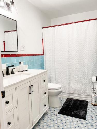 a bathroom with a white sink and a toilet at Changes In Latittude Retreat in Daytona Beach
