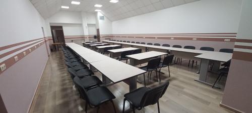 a large room with tables and chairs in it at Hotel Lago Peshtera in Peshtera