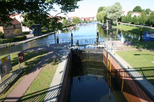 a view of a canal with a boat in it at Villa Seeschwalbe Plau in Plau am See