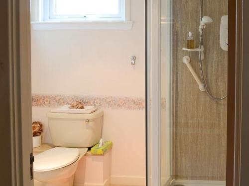 a bathroom with a toilet and a shower at Keith House in Thurso