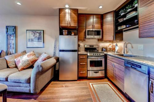 a kitchen with a couch and a refrigerator at Studio Condo 318 in Historic Frisco at Cedars Lodge in Frisco