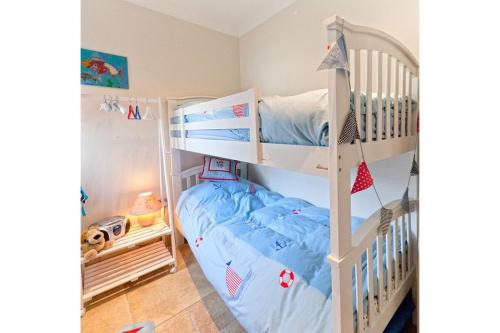 a bedroom with two bunk beds in a room at Pen Y Sarn in Abersoch