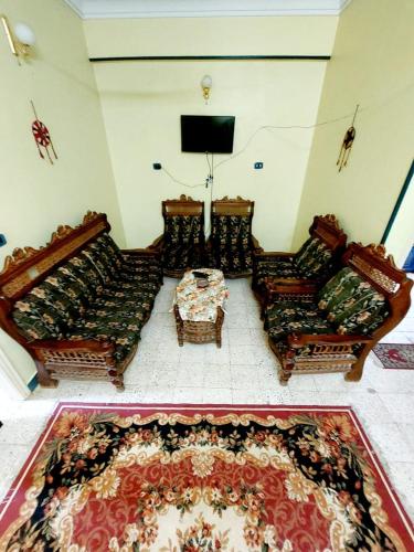 a living room with two couches and a table at Gamal Robob Nubian Guest House in Aswan