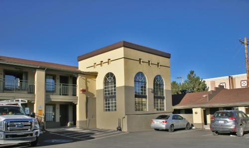 a church with cars parked in front of a parking lot at Super 8 by Wyndham NAU/Downtown Conference Center in Flagstaff