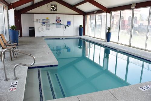 a swimming pool with blue water in a building at Super 8 by Wyndham NAU/Downtown Conference Center in Flagstaff
