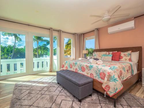 a bedroom with a bed with a view of the ocean at Newly Renovated 8 Bedroom Ocean Front Villa with Pool in Rio Grande