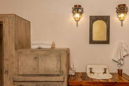a bathroom with a wooden cabinet and a sink at Amapola Loft in San Miguel de Allende