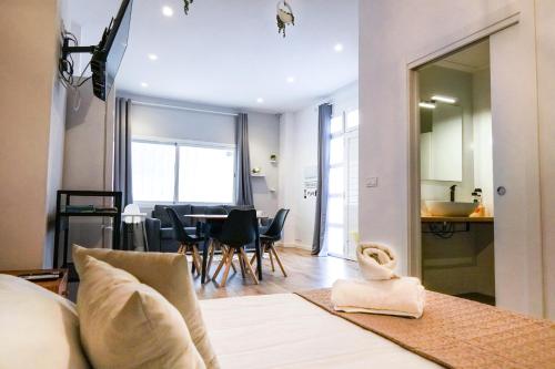 een woonkamer met een bank en een tafel met stoelen bij Playa Apartment in Valencia