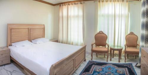 Łóżko lub łóżka w pokoju w obiekcie Bhurban Villas