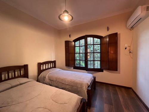 a bedroom with two beds and a window at Arrea Mutillak in Goya