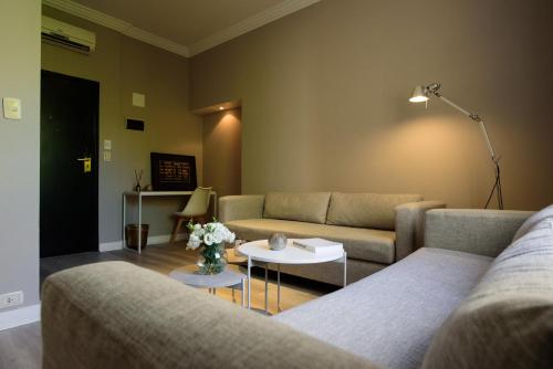 a living room with a couch and a table at SuMa Recoleta Hotel in Buenos Aires