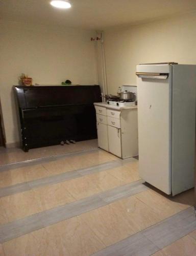a kitchen with a white refrigerator and a sink at Paraqar in Pʼarakʼar