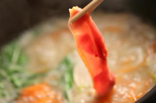 a carrot sticking out of a bowl of soup at Shosenkaku in Nagano