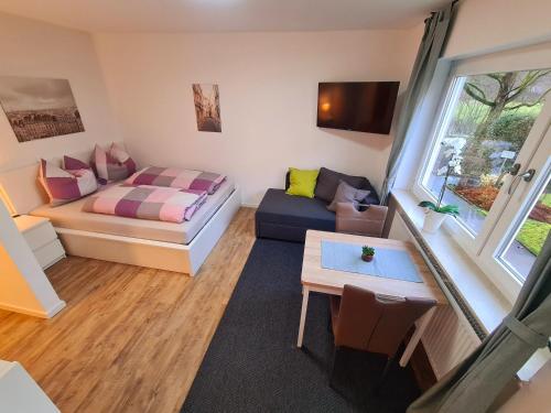 a small living room with a bed and a couch at Apartment Salinenpromenade Bad Kissingen in Bad Kissingen