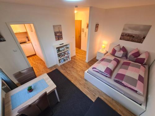 a bedroom with a large bed and a living room at Apartment Salinenpromenade Bad Kissingen in Bad Kissingen