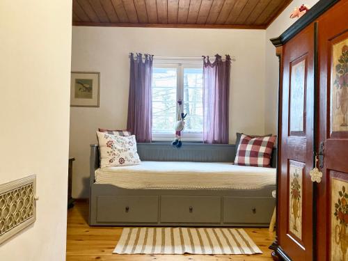 a bed in a room with a window at Willa Tyrolczyk in Karpacz