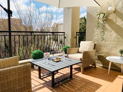 a patio with a table and chairs on a balcony at Homey 2-bedroom apartment & loft space in Sandton