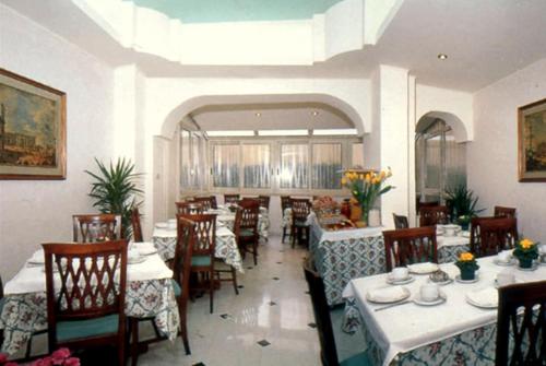 a dining room with tables and chairs in a restaurant at Hotel San Pietro in Rome