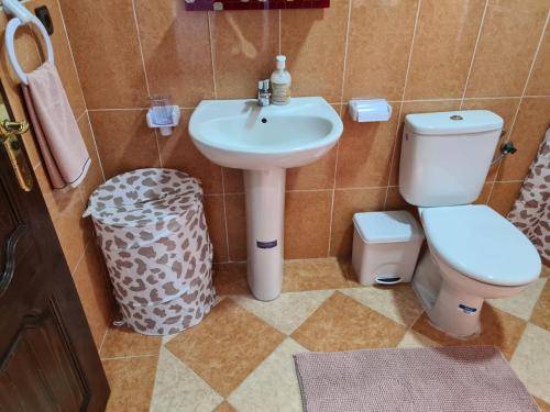 a bathroom with a sink and a toilet at Restaurante Cafe El Balcon in Beni Enzar