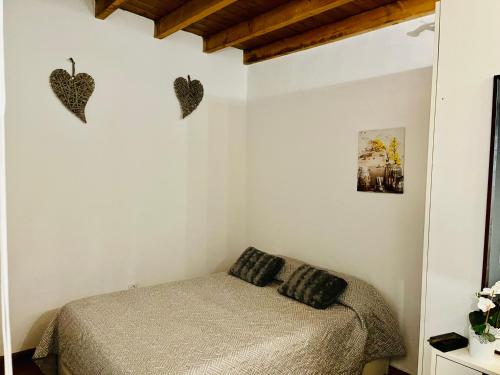 a bedroom with a bed and two hearts on the wall at Dakota’s house in Las Lagunas