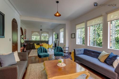 a living room with a couch and a table at Refurbished Mansion with Garden & Patio in Las Lomas - Monte Blanco in Mexico City