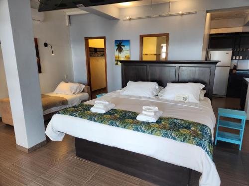 a bedroom with two beds with towels on them at Maya Beach Hotel in Maya Beach