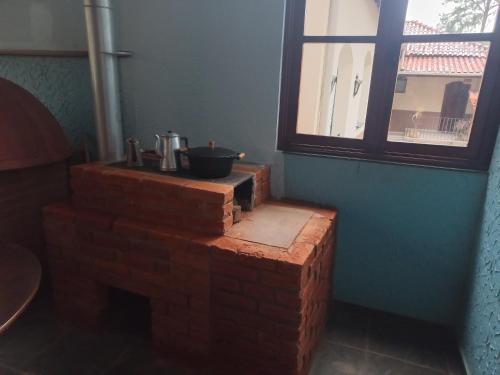 a stack of bricks sitting next to a window at Recanto Caminho das Águas in Caxambu