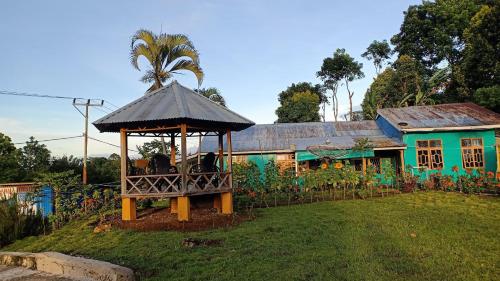 a house with a gazebo in a yard at Hobbit Hill in Ruteng