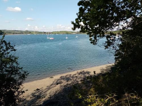 widok na plażę z łodziami w wodzie w obiekcie petite maison chaleureuse w mieście Irvillac