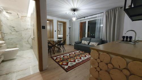 a living room with a couch and a living room with at Apartamenty Nowa Osada - by VillaOlimpijska2 in Wisła