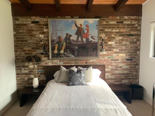 a bedroom with a brick wall with a bed at [RARE] Buckhead Mid-century Masterpiece! in Atlanta