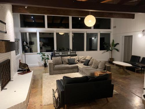 a living room with a couch and a fireplace at [RARE] Buckhead Mid-century Masterpiece! in Atlanta
