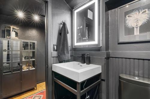 a bathroom with a white sink and a toilet at The Black Nest - Hot Tub Romantic Getaway in Guerneville
