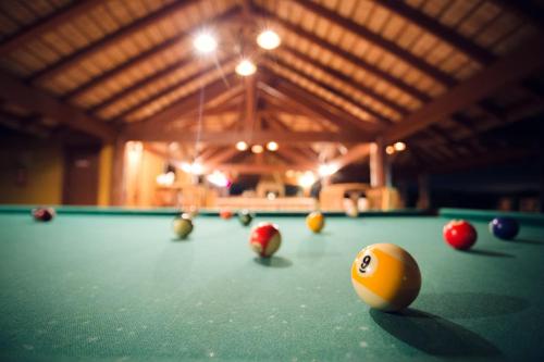 a pool table with balls on top of it at Pousada Boyrá in Bonito