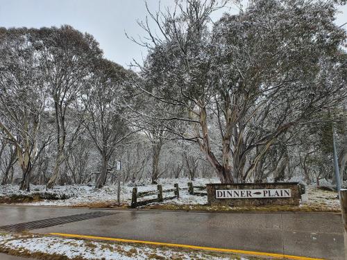 a sign for the dyer plantation in the snow at SNOWED INN apartment in Dinner Plain