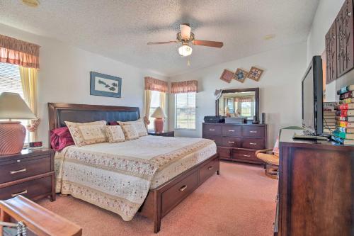 a bedroom with a bed and a ceiling fan at Lady Lake House with Lanai and Community Pool! in Lady Lake